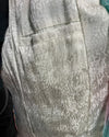 Close-up of a textured lining in the spirithoods Doll Party Faux Fur Calf Length Coat showing the inner welt pocket with a subtle snakeskin pattern