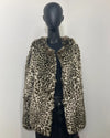 Leopard print faux fur jacket on a mannequin against a white background