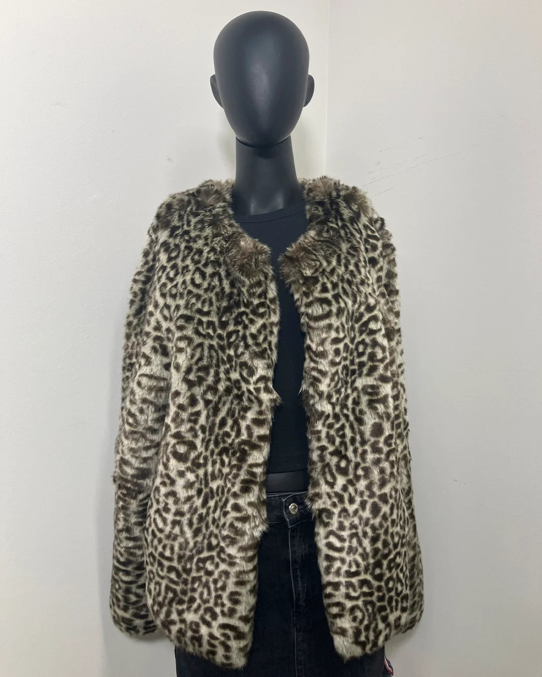 Leopard print faux fur jacket on a mannequin against a white background
