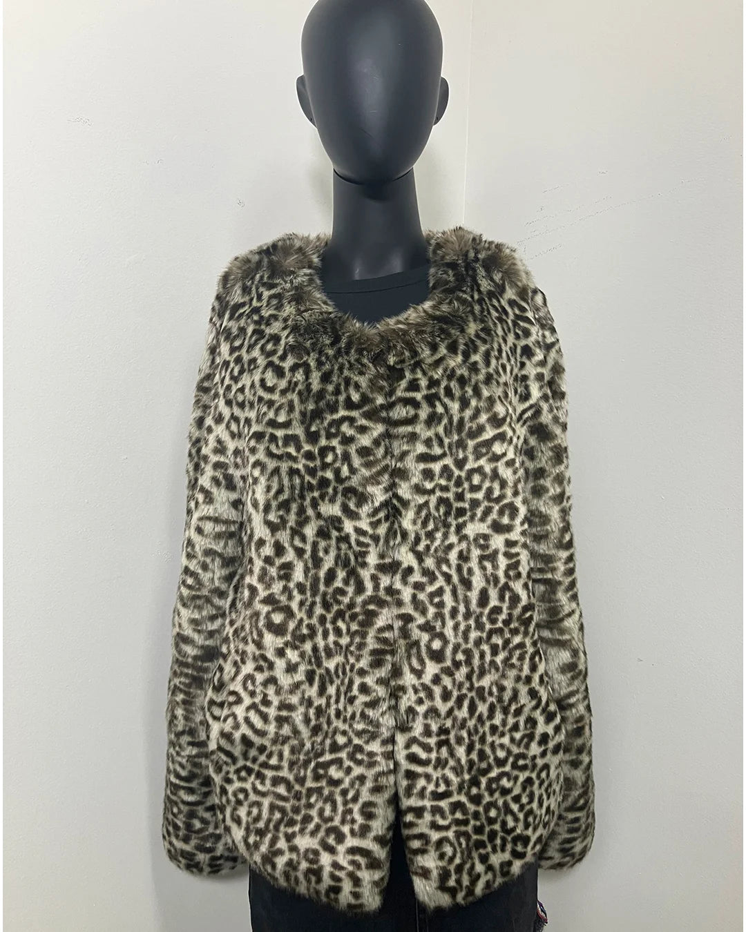 Leopard print faux fur bomber jacket on a mannequin against a white background