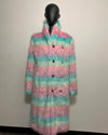 Multicolored striped faux fur coat on a mannequin against a plain background