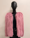 Pink fluffy jacket on a mannequin against a beige background