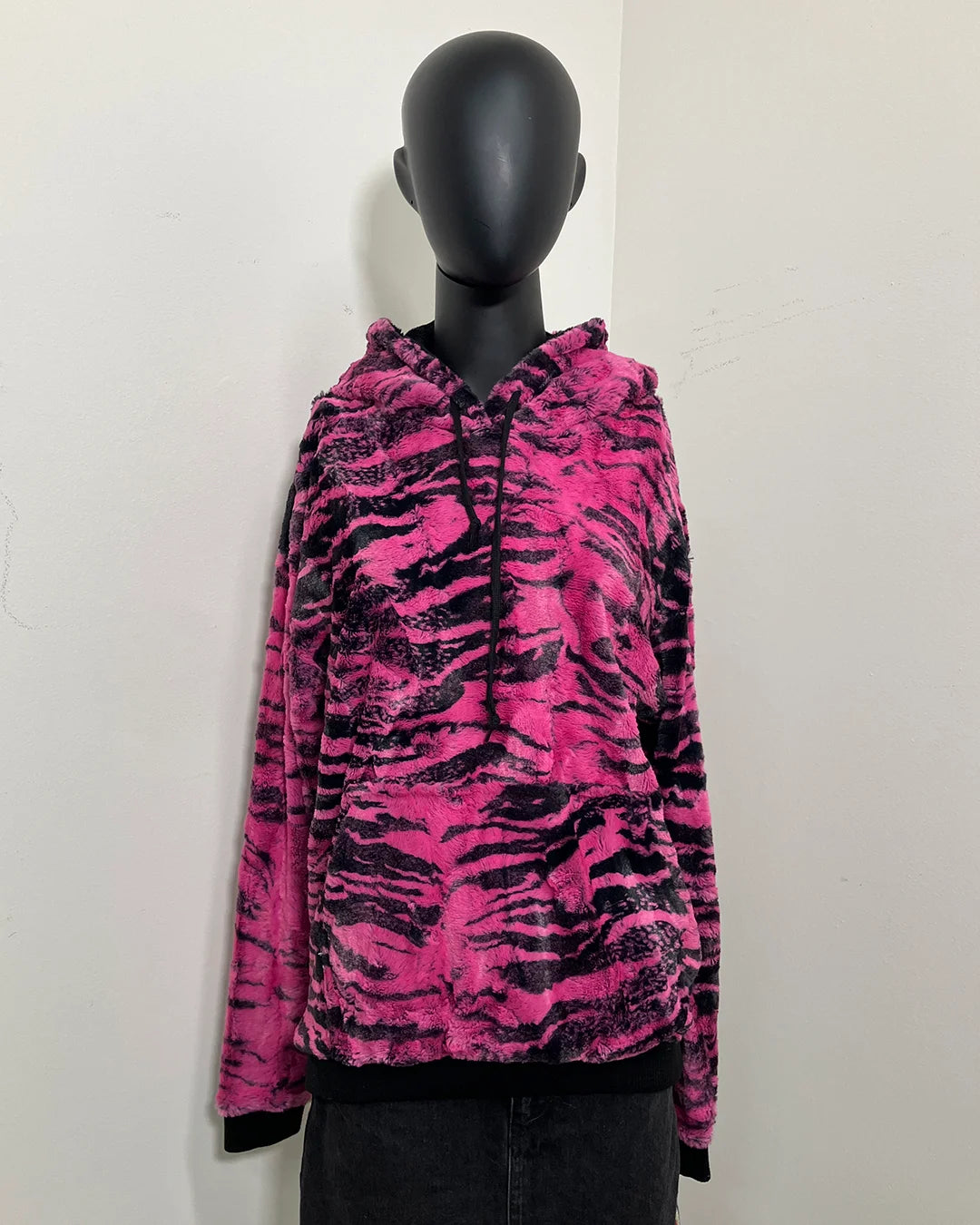 mannequin wearing a pink and black raspberry tiger inspired hoodie with the hood down. front kangaroo pocket