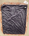 Black lining on red wolf pet bed  on a beige surface