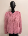 Pink fluffy jacket on a mannequin against a plain background