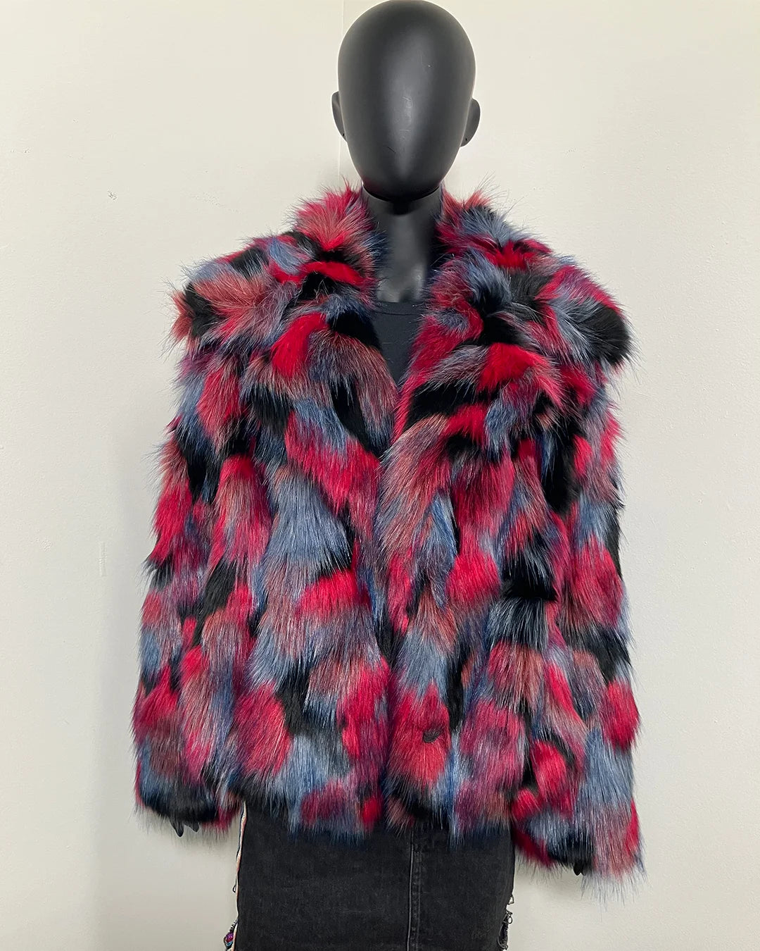 Multicolored faux fur coat in blues, reds and blacks on a mannequin against a white background. Oversized collar - this is part of SpiritHoods online Sample Sale items.