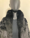 Mannequin wearing a black faux fur coat with a plain background with the collar up. SpiritHoods Online Sample Sale Style: Faux Fur Coat in Black Panther Size XXS