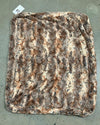 Brown textured faux fur pet bed on a concrete surface