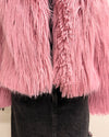 Close-up of a pink fluffy garment with a black background