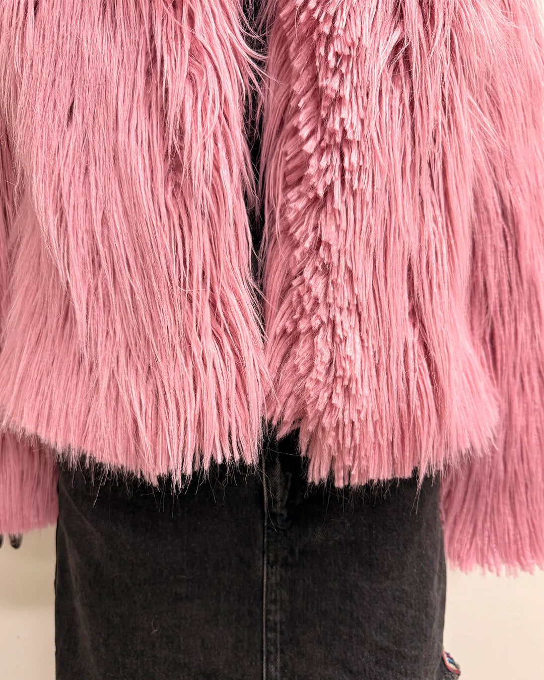 Close-up of a pink fluffy garment with a black background