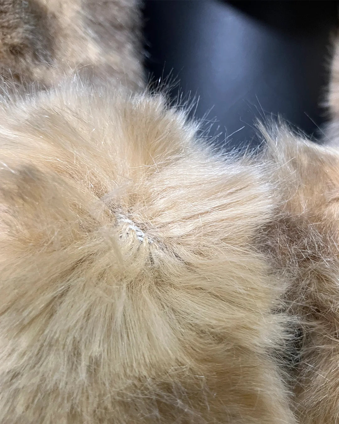 Close-up of a areas in the faux fur that are not as dense as the standard quality, which is why this coat is 60% off.