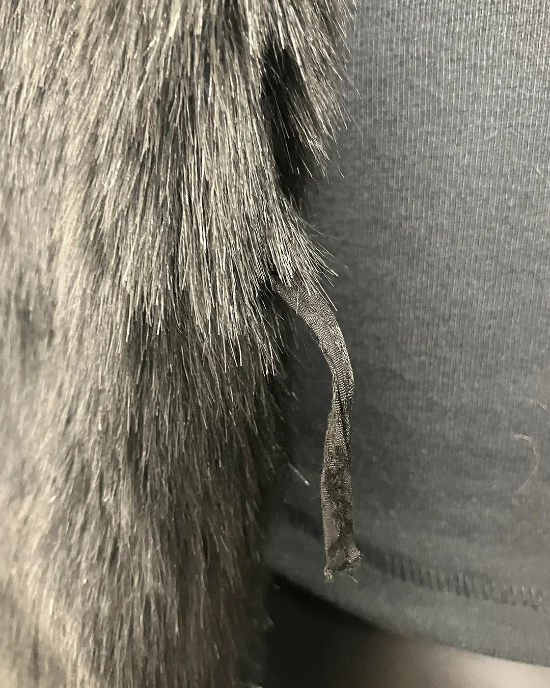 Close Up of the Broken Button Loop on the Coat - SpiritHoods Online Sample Sale Style: Faux Fur Coat in Black Panther Size XXS