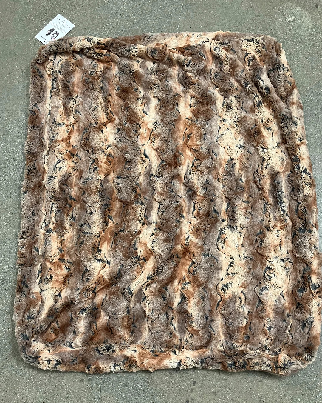 Brown textured fake fur fabric on a gray background