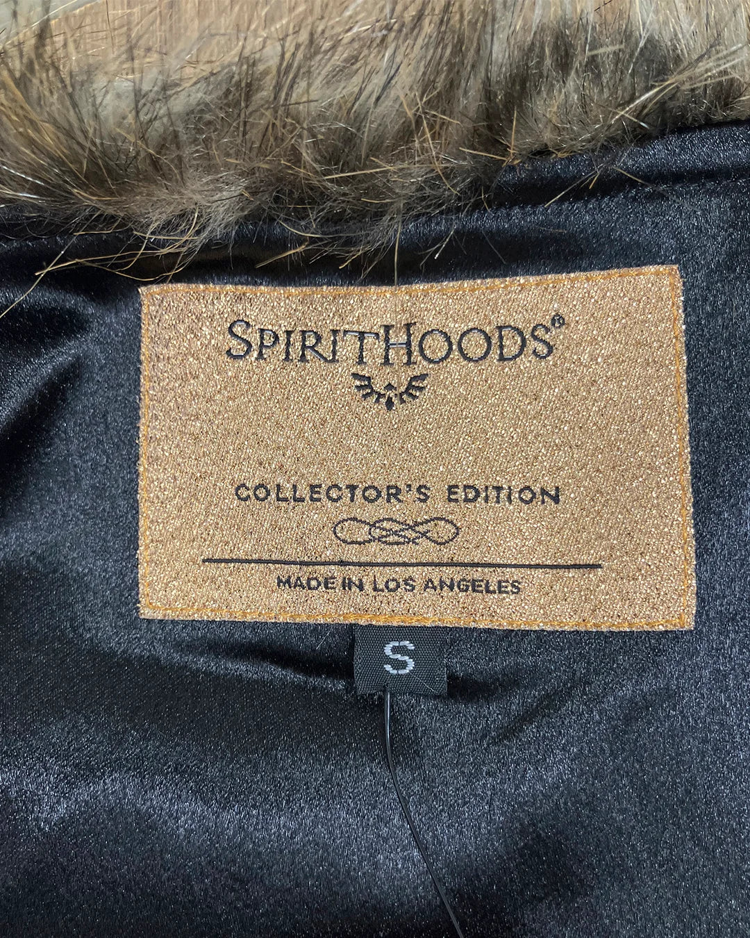 Neck Label on a dark poly-satin lining fabric item with 'Spirithoods' branding and text. Showing Collector Edition Item - Made in Los Angeles.