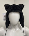 Black furry hat with cat ears on a mannequin head 
