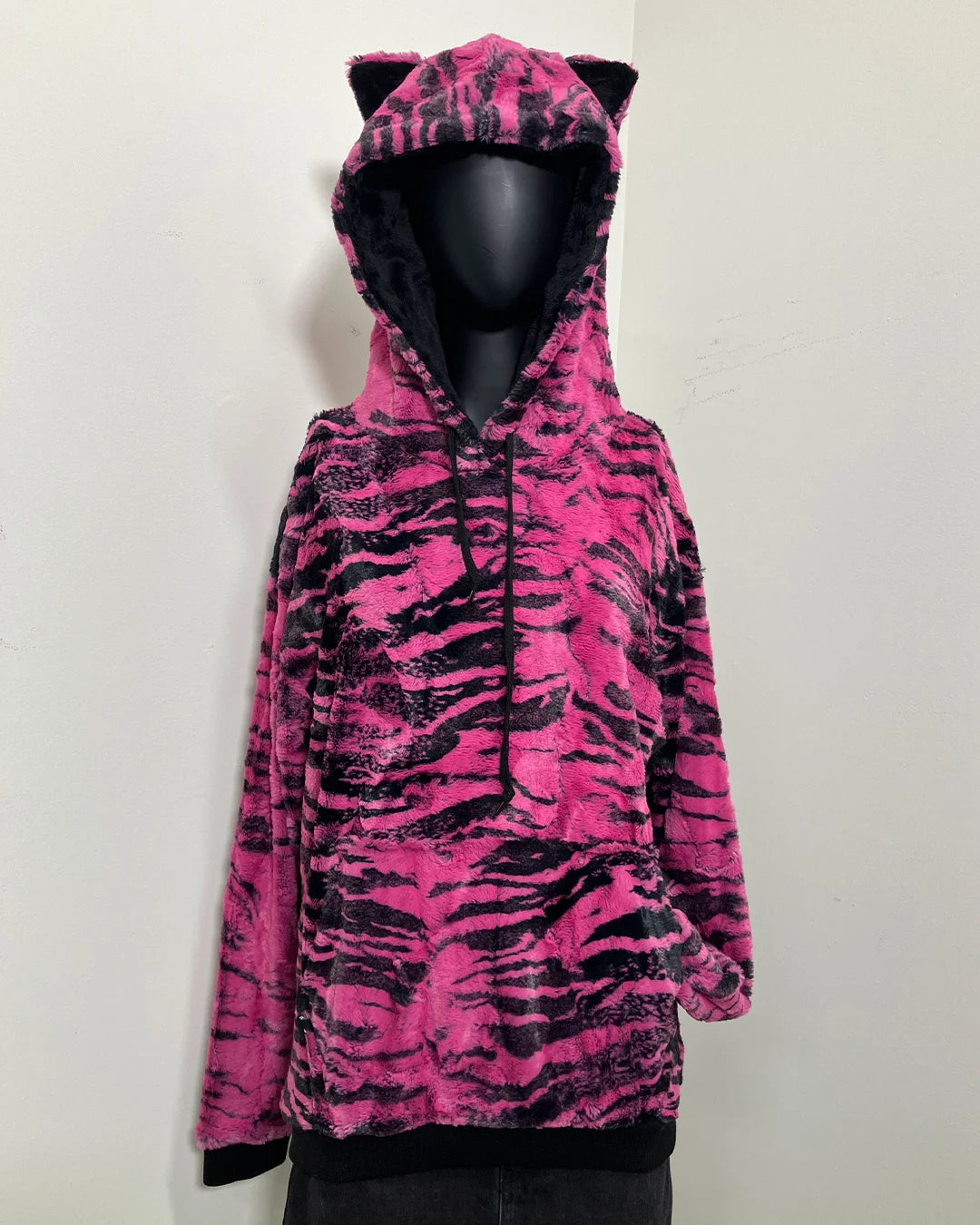 mannequin wearing a pink hoodie with black tiger stripes with a hood and tiny cat ears.