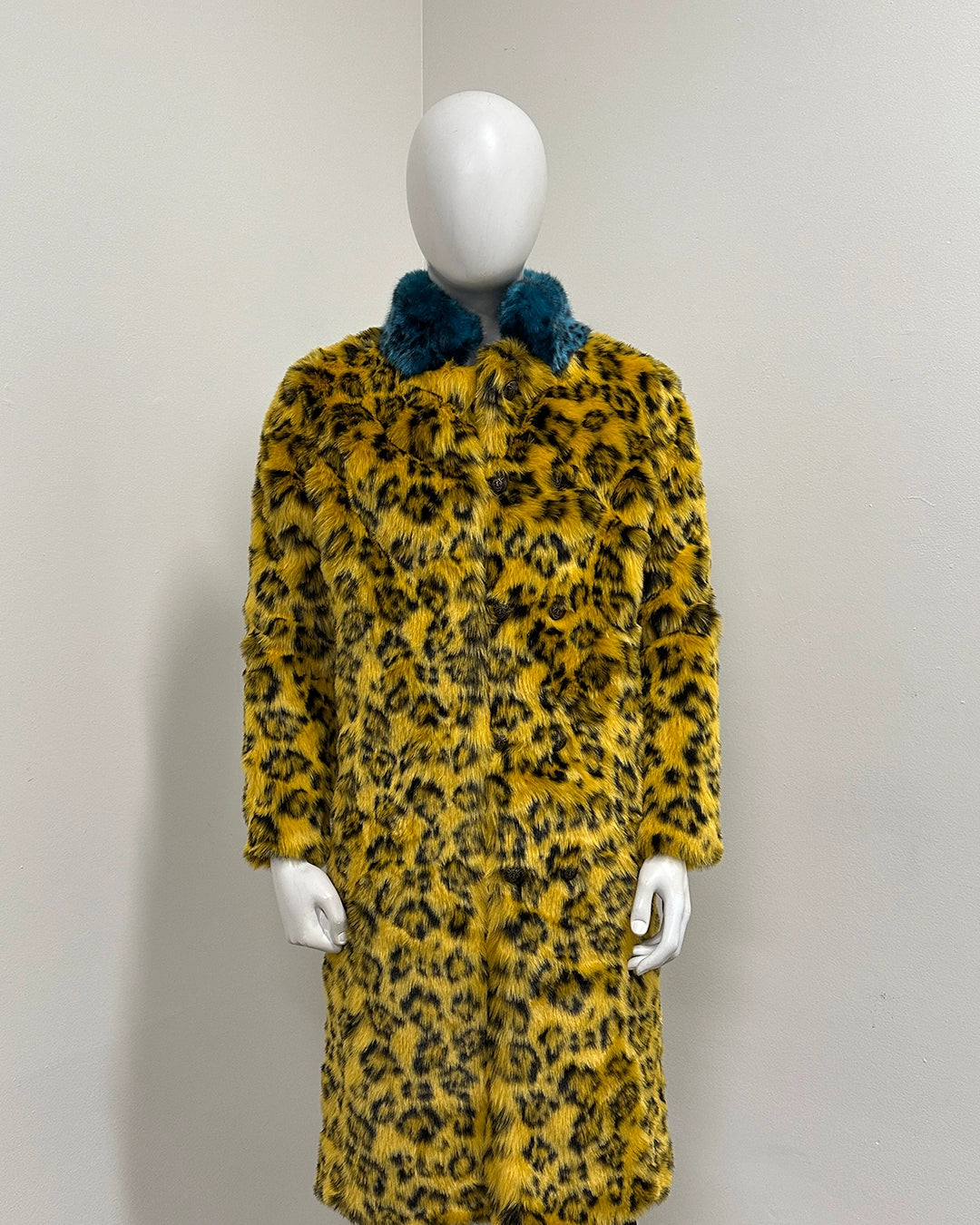 Long yellow leopard print coat on a mannequin 