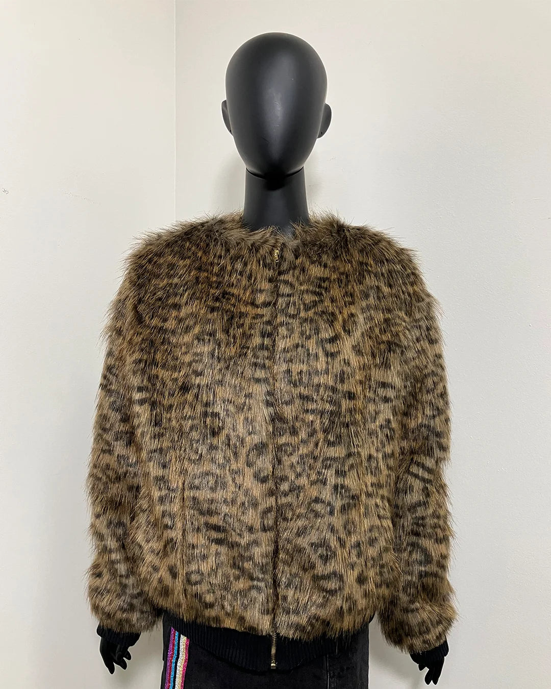 Mannequin wearing a leopard print faux fur coat against a white background in a size small with front zipper closure