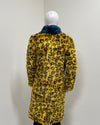 Back view of yellow leopard print faux fur coat on a mannequin

