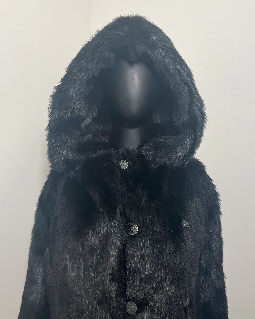 All Black Faux Fur Coat with an oversized hood, up close photo of the top button and hood on the mannequin and sleek black short-pile, fake fur. SpiritHoods Online Sample Sale Style: Hooded Faux Fur Coat - Black Panther in Size X-SMALL