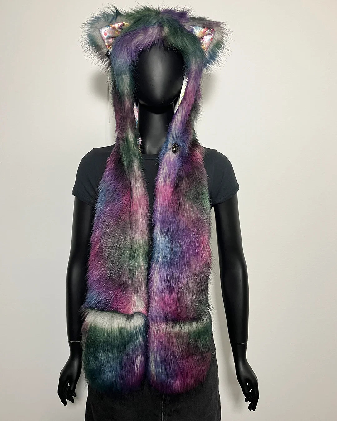Multicolored fake fur hoodie with scarf on a mannequin against a plain background