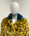 yellow leopard print faux fur coat with blue fur collar on a mannequin