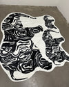 Black and white abstract pattern fur rug on a concrete floor