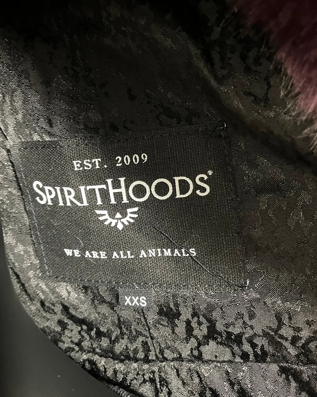 Close Up of SpiritHoods Necklabel in the Online Sample Sale Classic Luxe Purple Fake Fur Jacket in Lavender Panther in size XXS