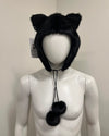 Black faux fur cat ear hat on a mannequin with a neutral background