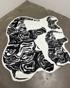 Black and white patterned fur rug shaped like a cat  
