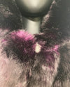 Close-up of a fluffy purple faux fur coat where the plush faux fur meets the wolf face button closure.
