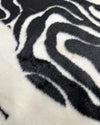 Close-up of a zebra-striped pattern fur rug