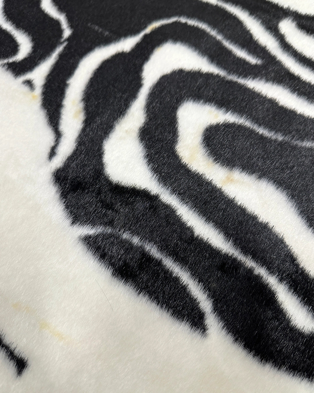 Close-up of a zebra-striped pattern fur rug