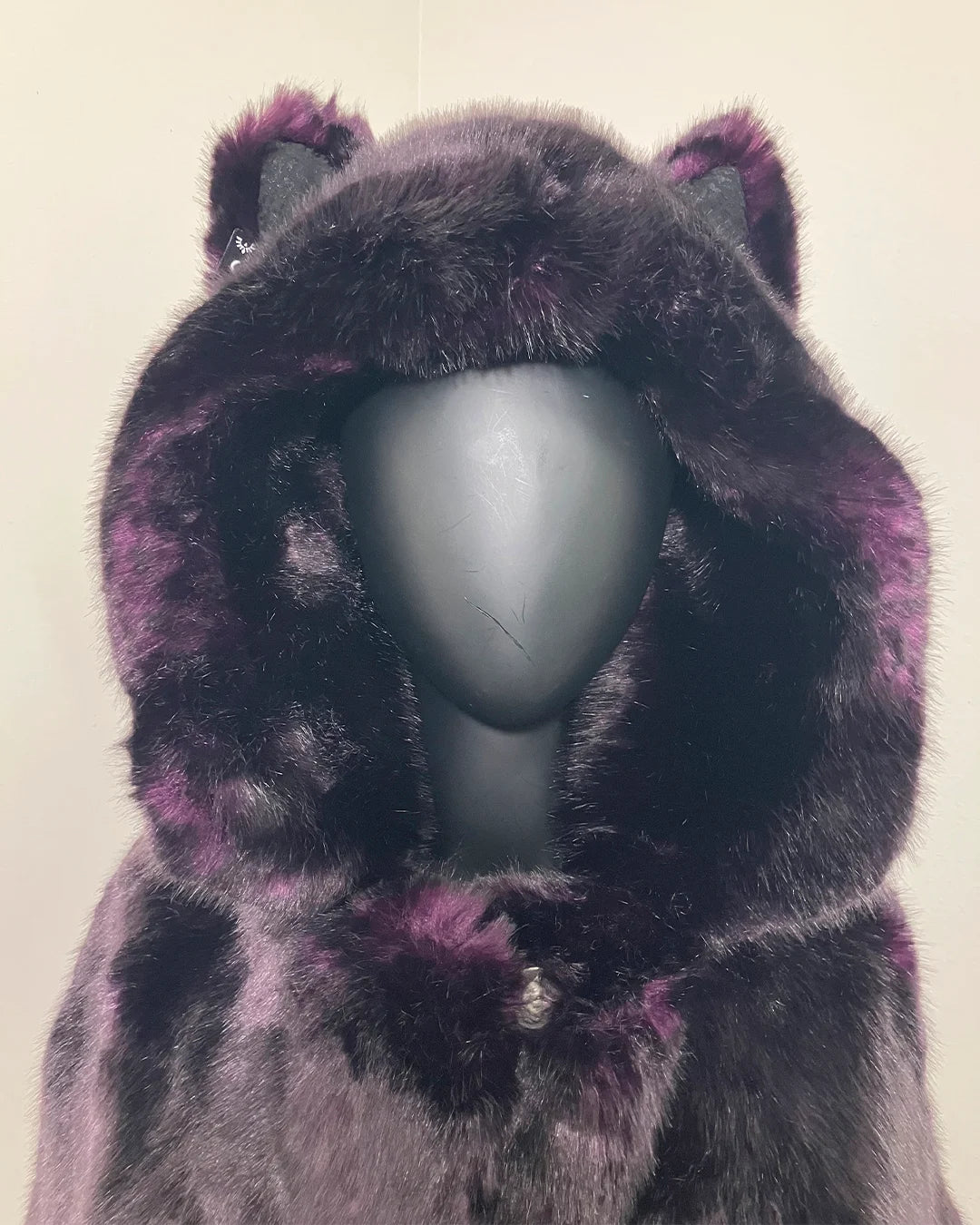 Close Up Photo of the Midnight Wolf Faux fur coat with hood on a mannequin against a plain background