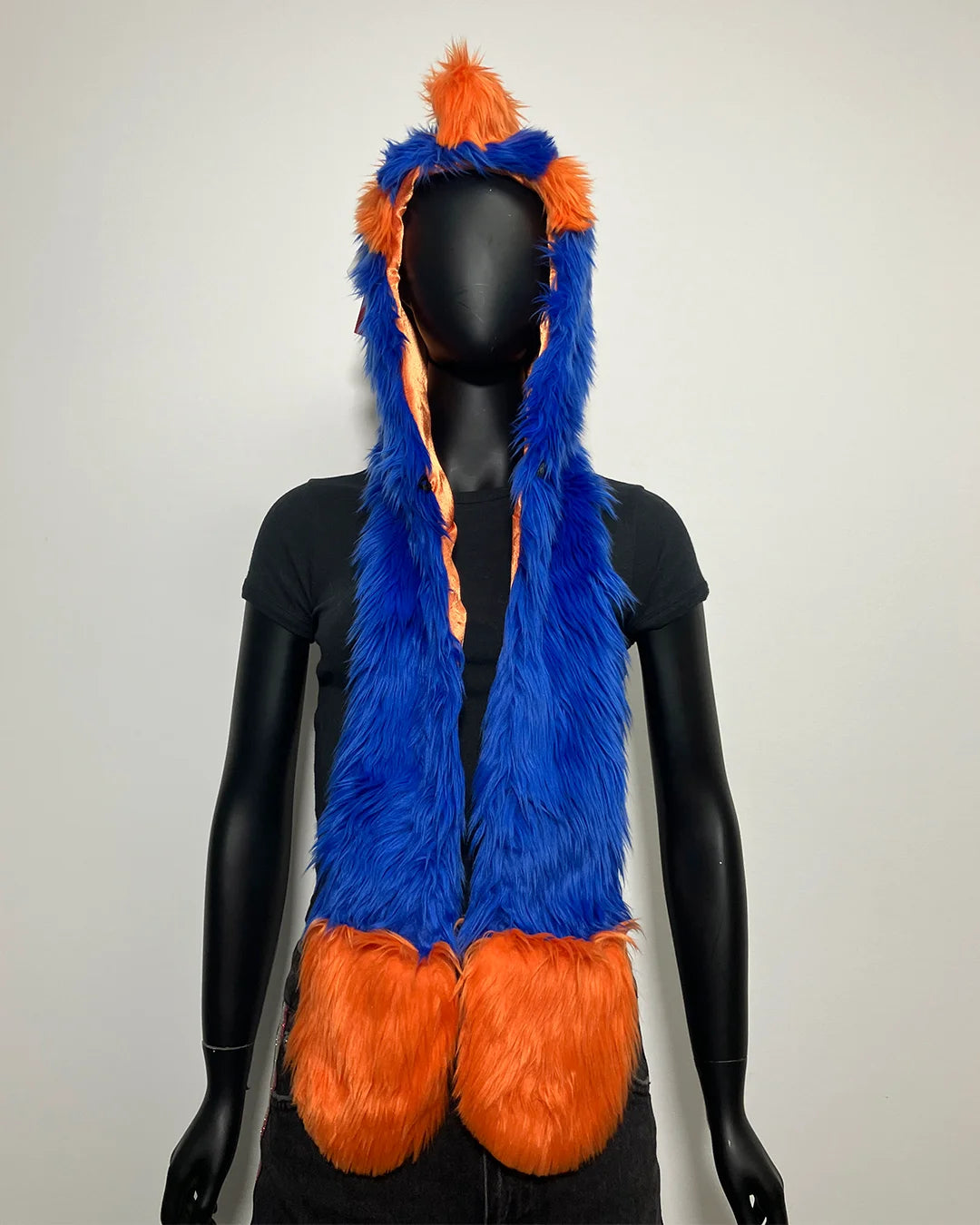 Blue and orange furry hood with hood on a mannequin against a white background