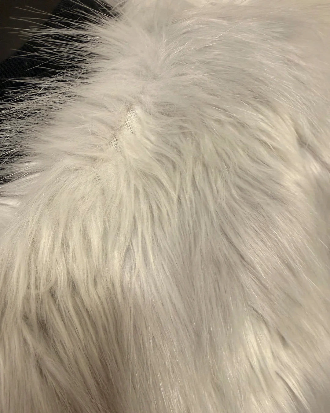 Close-up of white fake fur fabric with a soft texture
