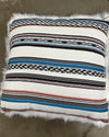 Decorative pillow with striped pattern with faux fur on the other side.
