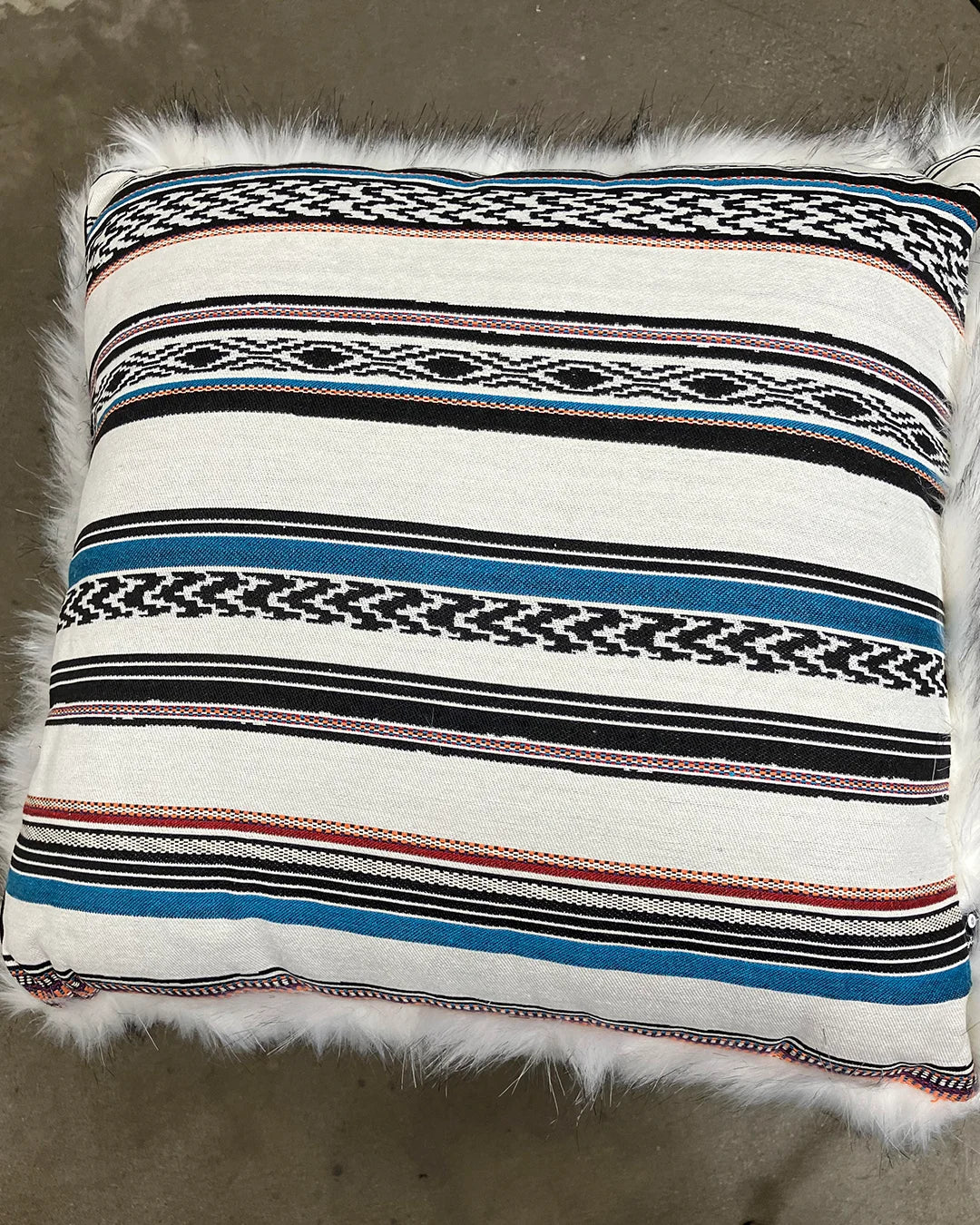 Decorative pillow with striped pattern with faux fur on the other side.