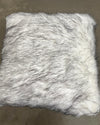 husky inspired white and black faux fur pillow on a brown background