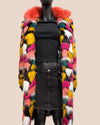 Mannequin wearing a colorful faux fur coat with a neutral background