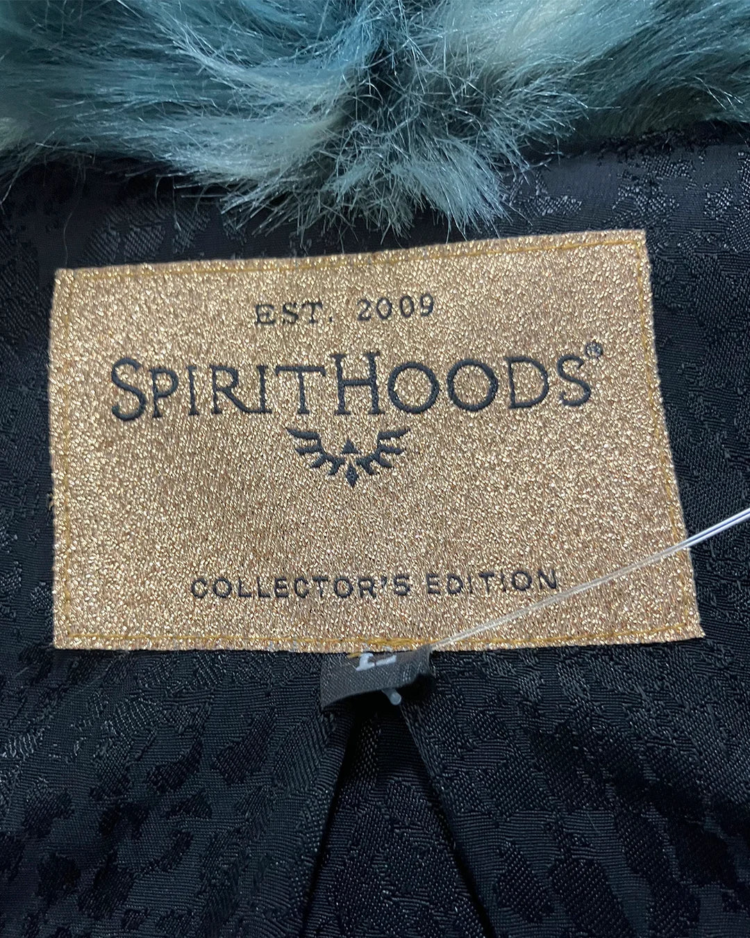Spirithoods collector's edition label on a dark background with teal fur.