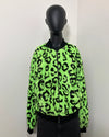 Neon green leopard print short pile faux fur jacket on a mannequin against a white background