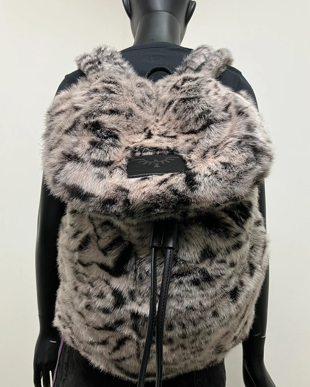 Faux Fur backpack with a black SpiritHoods faux leather label on a mannequin against a white background