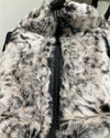Close-up of a white tiger fake fur duffle bag with a zipper, showing texture and pattern.