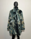 Faux Fur coat on a mannequin against a plain background