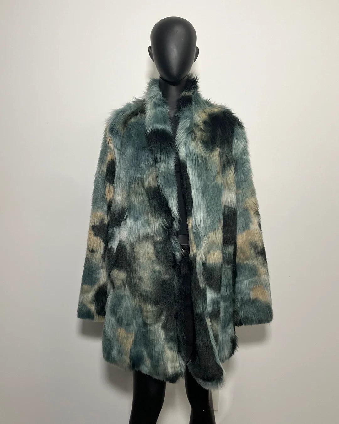 Faux Fur coat on a mannequin against a plain background