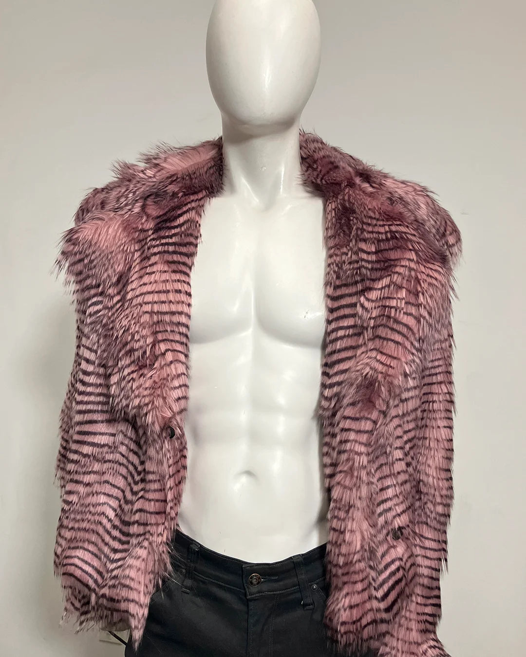 A pink and black feather-patterned faux fur jacket displayed on a white torso mannequin against a plain light gray background.