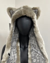 Mannequin wearing a fur hood with fox ears and patterned scarf 
