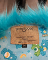 Label with 'SpiritHoods' branding on a product with blue feathered texture and colorful design in the background.