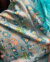 Fabric with Care Bears pattern on a gray background
